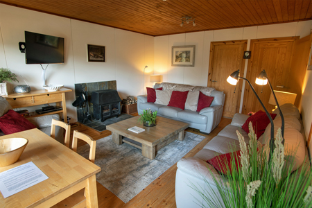 Lounge with log burner at Self Catering Chalet Salen Ardnamurchan Scotland